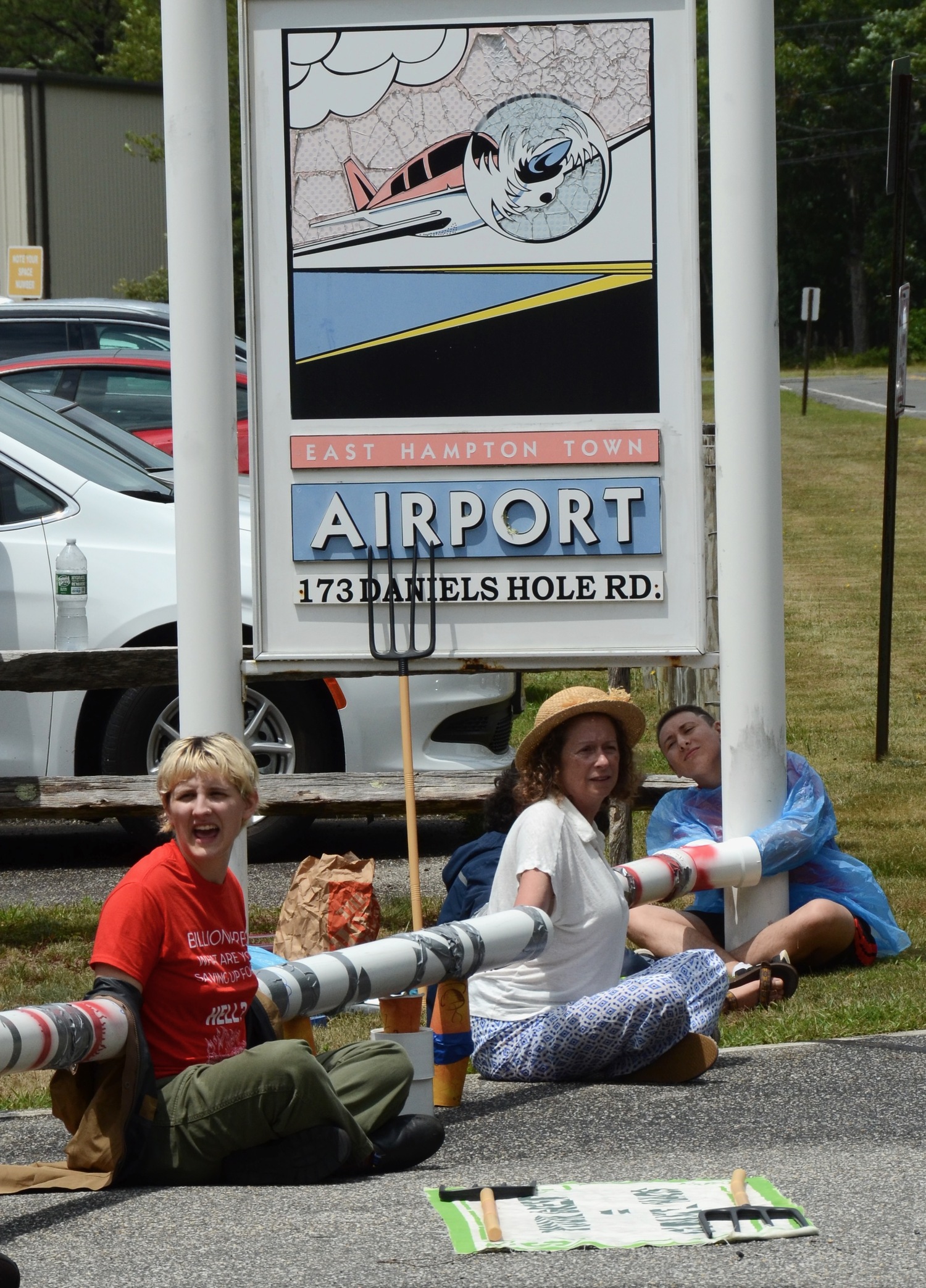 Protesters, including Abigail Disney, second from left, attempted to block access to East Hampton Airport on Friday afternoon, to protest the outsized contribution that private aircraft usage has on climate change.   KYRIL BROMLEY