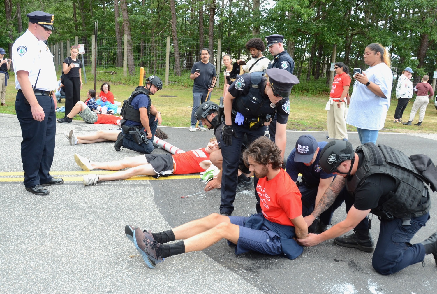 Protesters attempted to block access to East Hampton Airport on Friday afternoon, to protest the outsized contribution that private aircraft usage has on climate change.   KYRIL BROMLEY