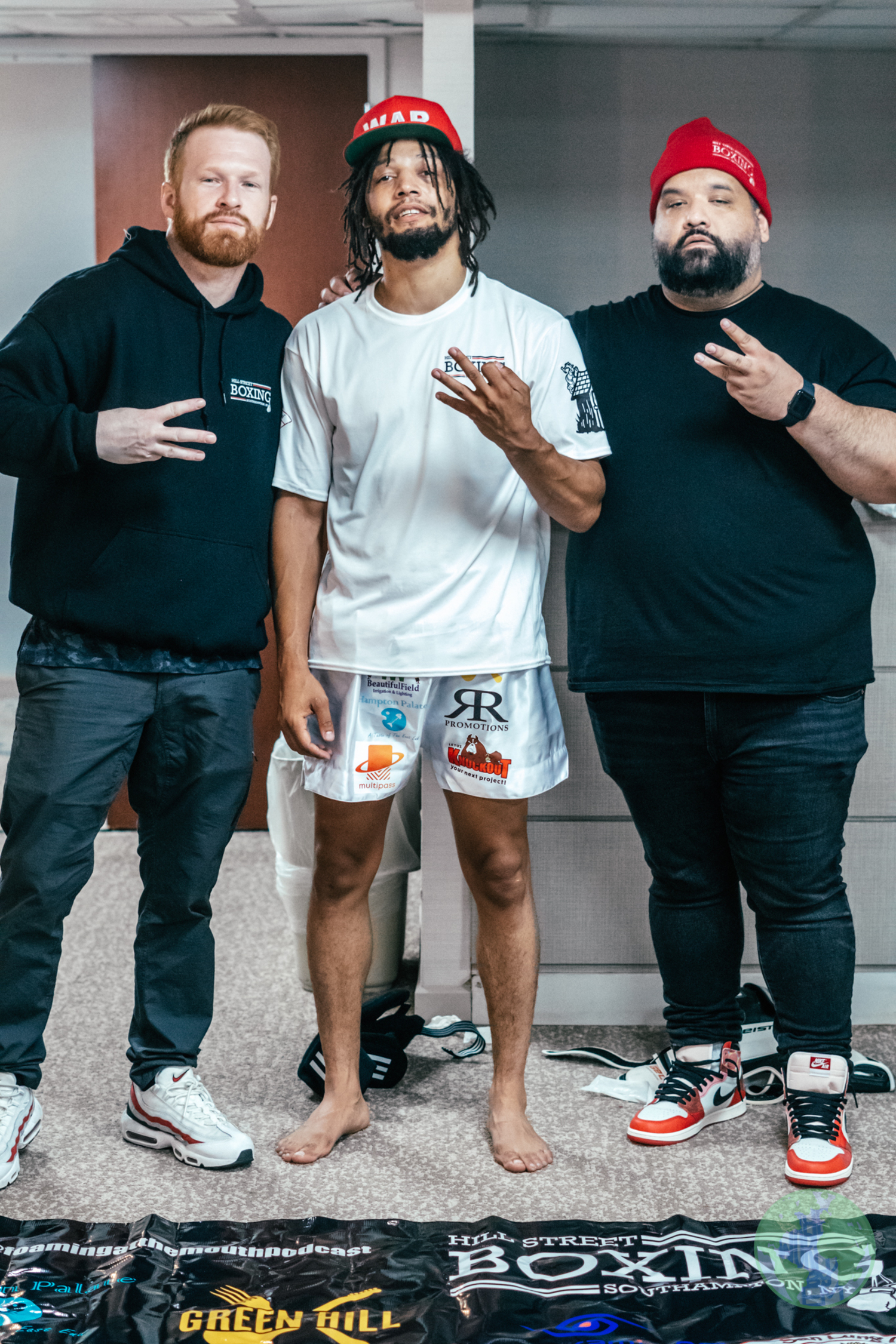 Neko Gettling, flanked by his trainers Avery Crocker, left, and Alan Quinones, after winning his third professional MMA fight on July 1.    THE WORLD BY EM