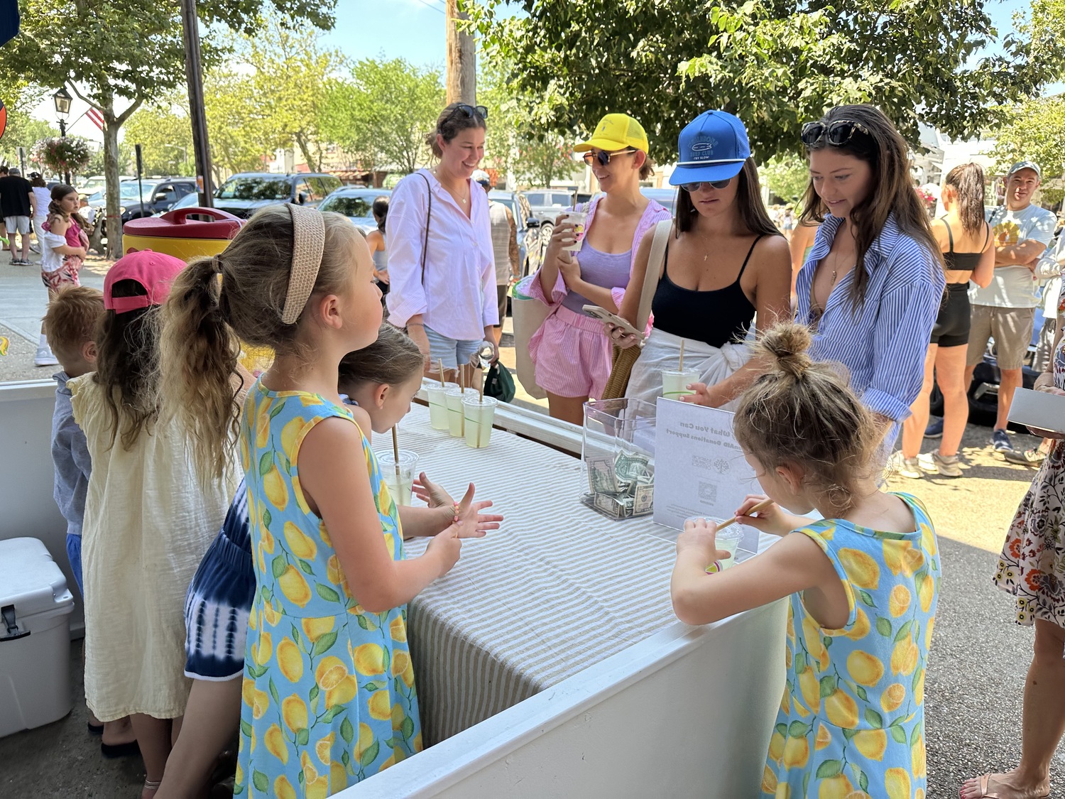 Sisters Fiona and Maeave Scissons, 8 and 6, have made more than $3,000 in three days selling fresh-squeezed lemonade in Sag Harbor. The money will go to Hamptons Community Outreach.