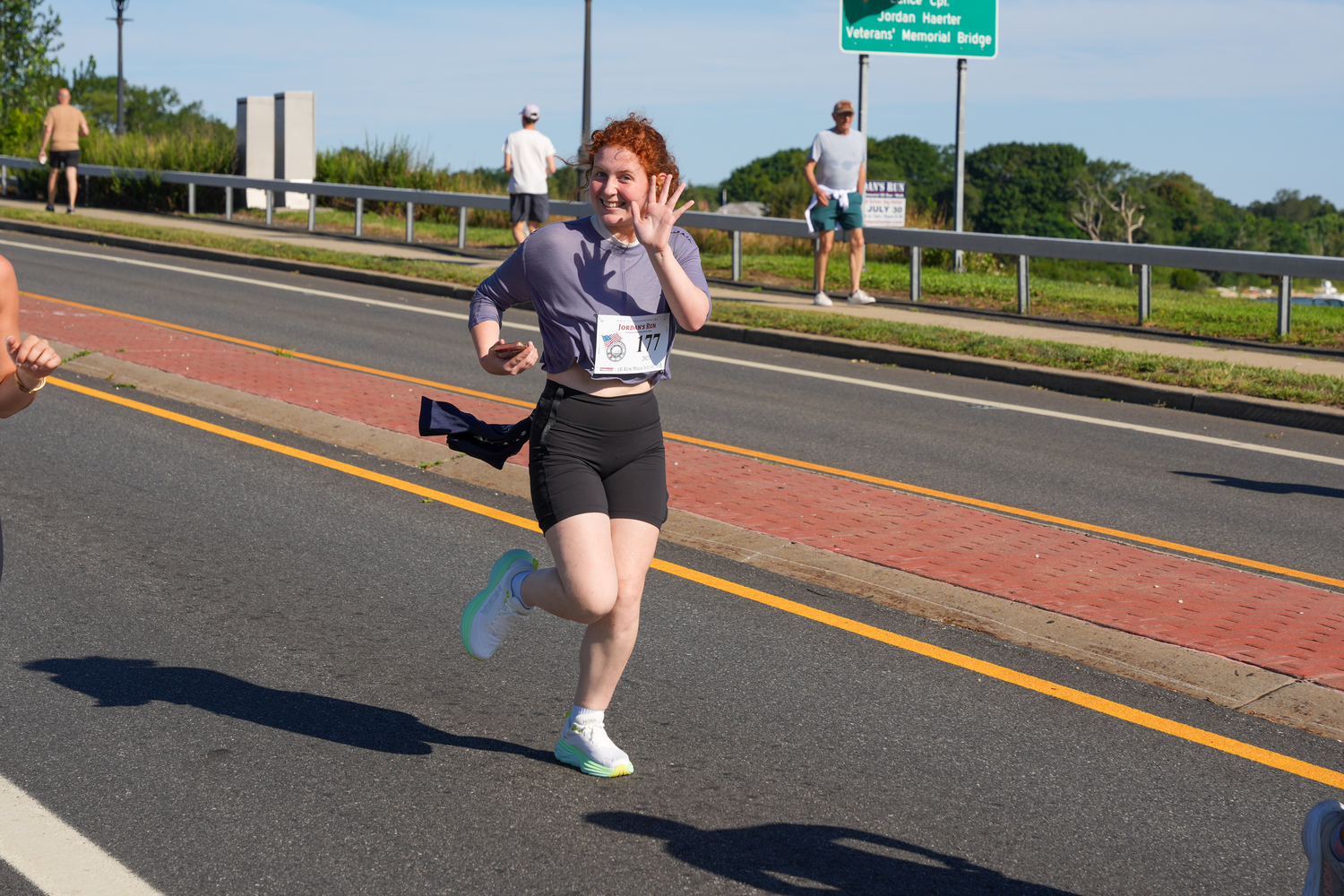 Allison Rishel of Water Mill gives a wave.   RON ESPOSITO