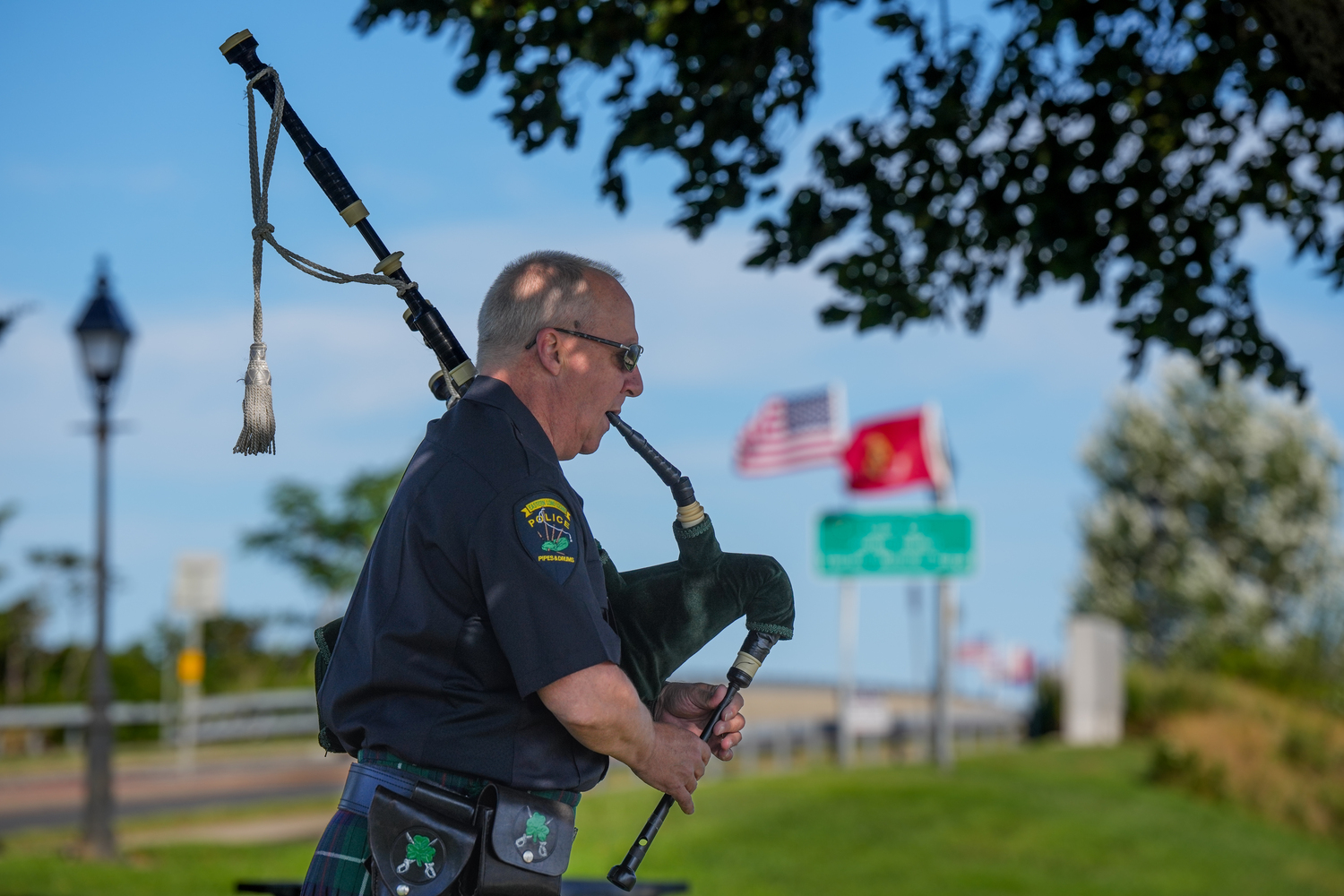 Todd Bennett of the Eastern Long Island Police Pipes & Drums plays near the Lance Cpl. Jordan Haerter Veterans’ Memorial Bridge.    RON ESPOSITO