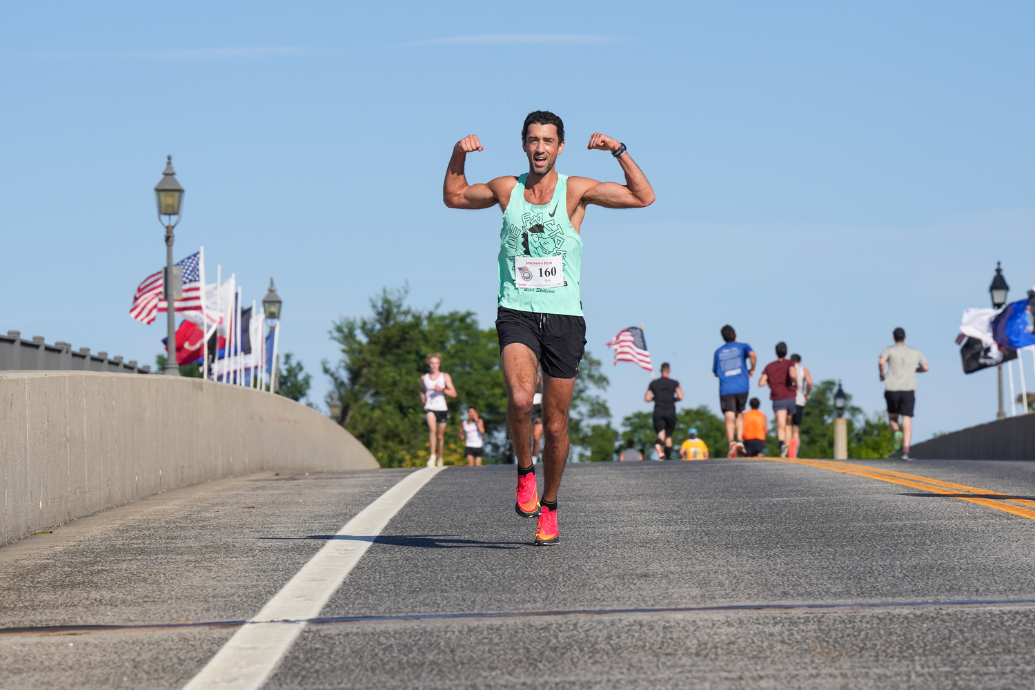 Ben Fleischman flexes as he runs over the Lance Cpl. Jordan Haerter Veterans’ Memorial Bridge.   RON ESPOSITO