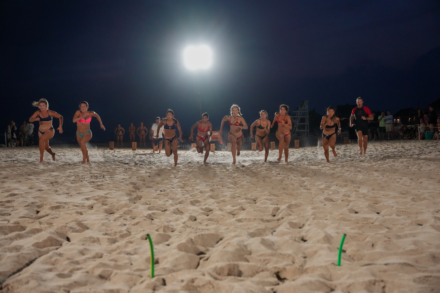 The women descend to the line of beach flags.   RON ESPOSITO