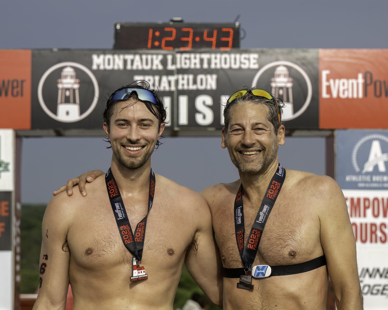 Shai Turner, right, and another triathlete at the finish.  MARIANNE BARNETT