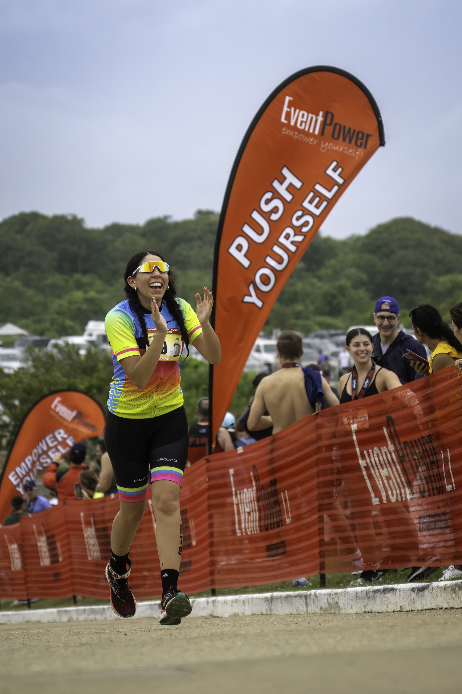 A triathlete is happy to see the finish line.   MARIANNE BARNETT