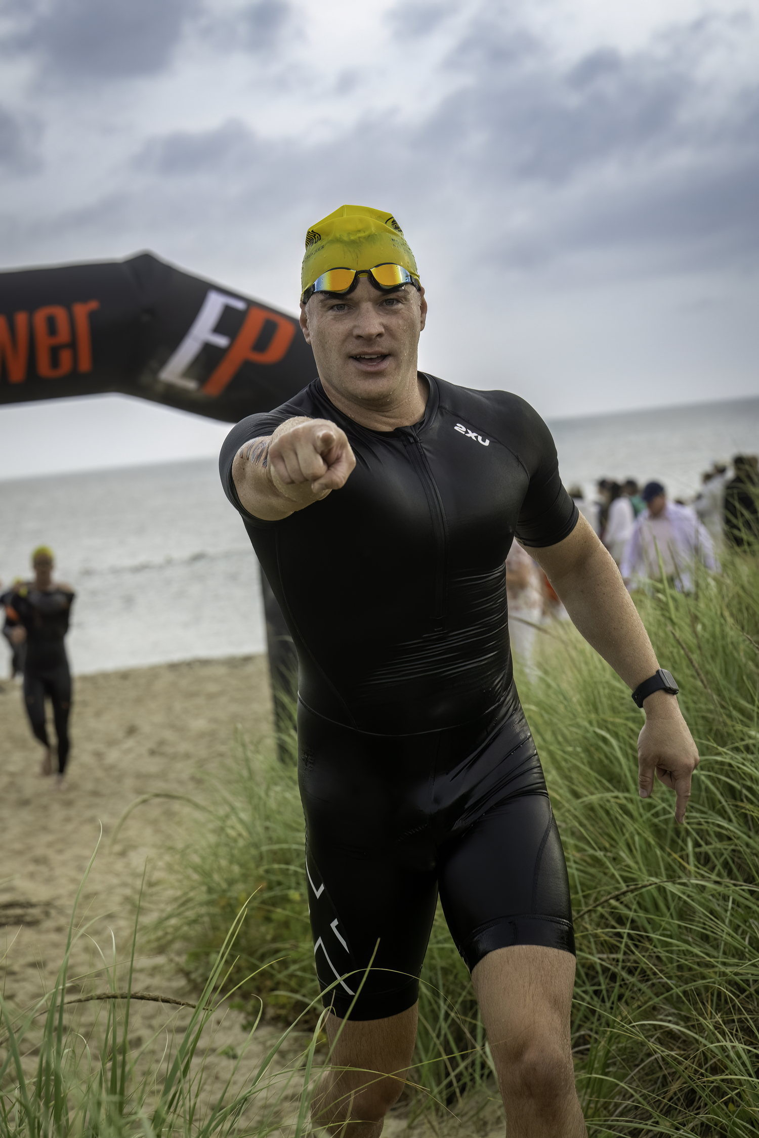 A triathlete gets out of the water.   MARIANNE BARNETT