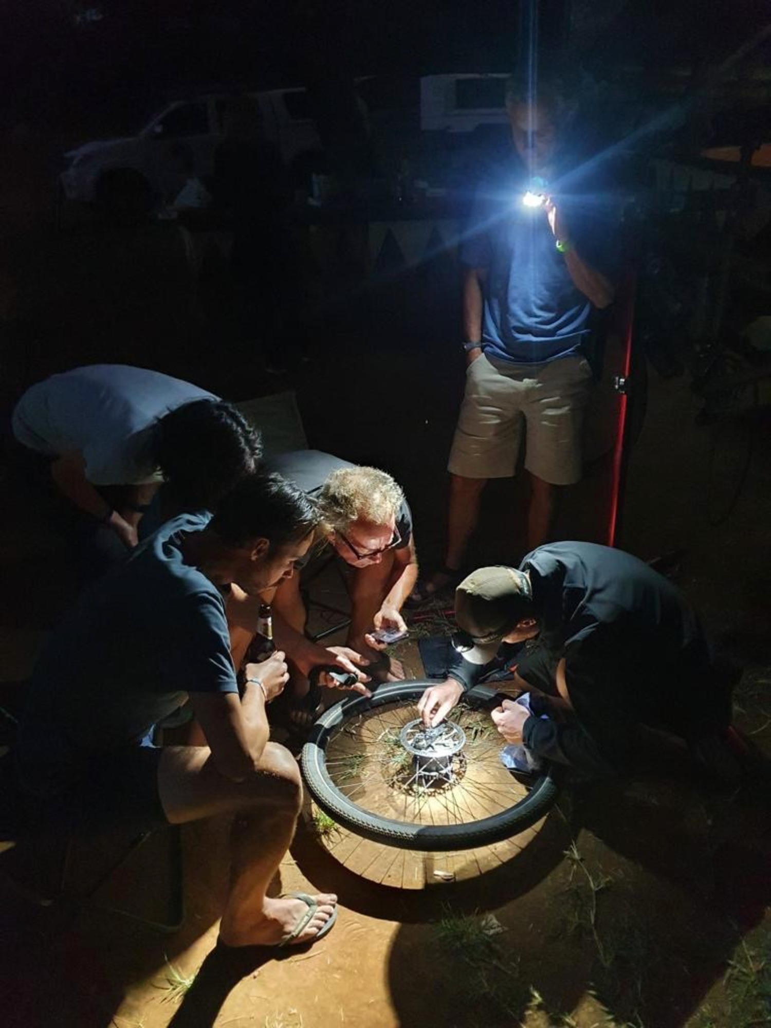 Repairing a wheel hub during a blackout in Luksaka, Zambia. COURTESY JOE LOUCHHEIM