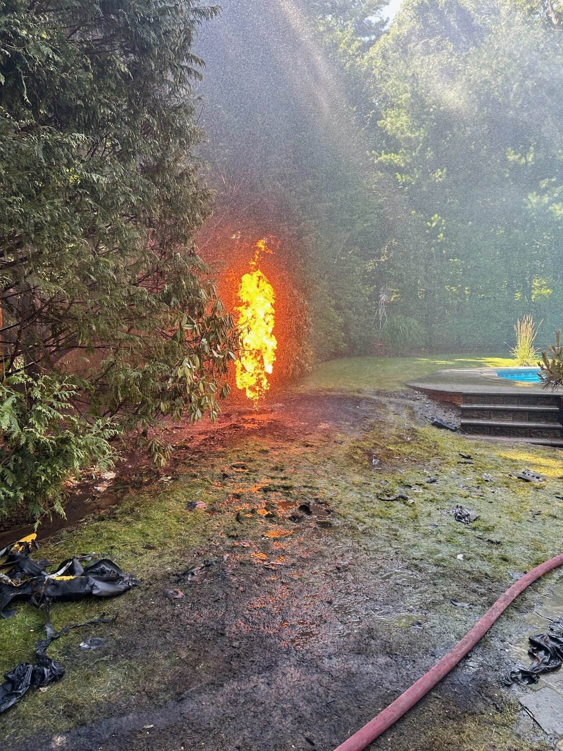 Flames shoot up from an underground gas tank at a Clinton Street home on Saturday. A broken pressure relief valve presented firefighters from the Springs Fire Department with a unique and dangerous situation.