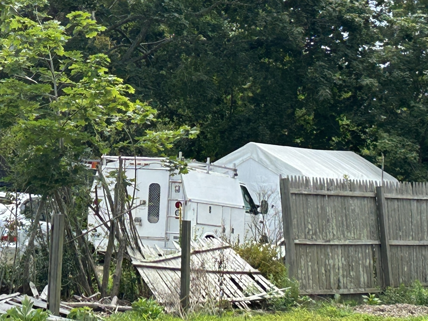 Neighbors have complained of the falling fence on Ponquogue Avenue in Hampton Bays.   KITTY MERRILL