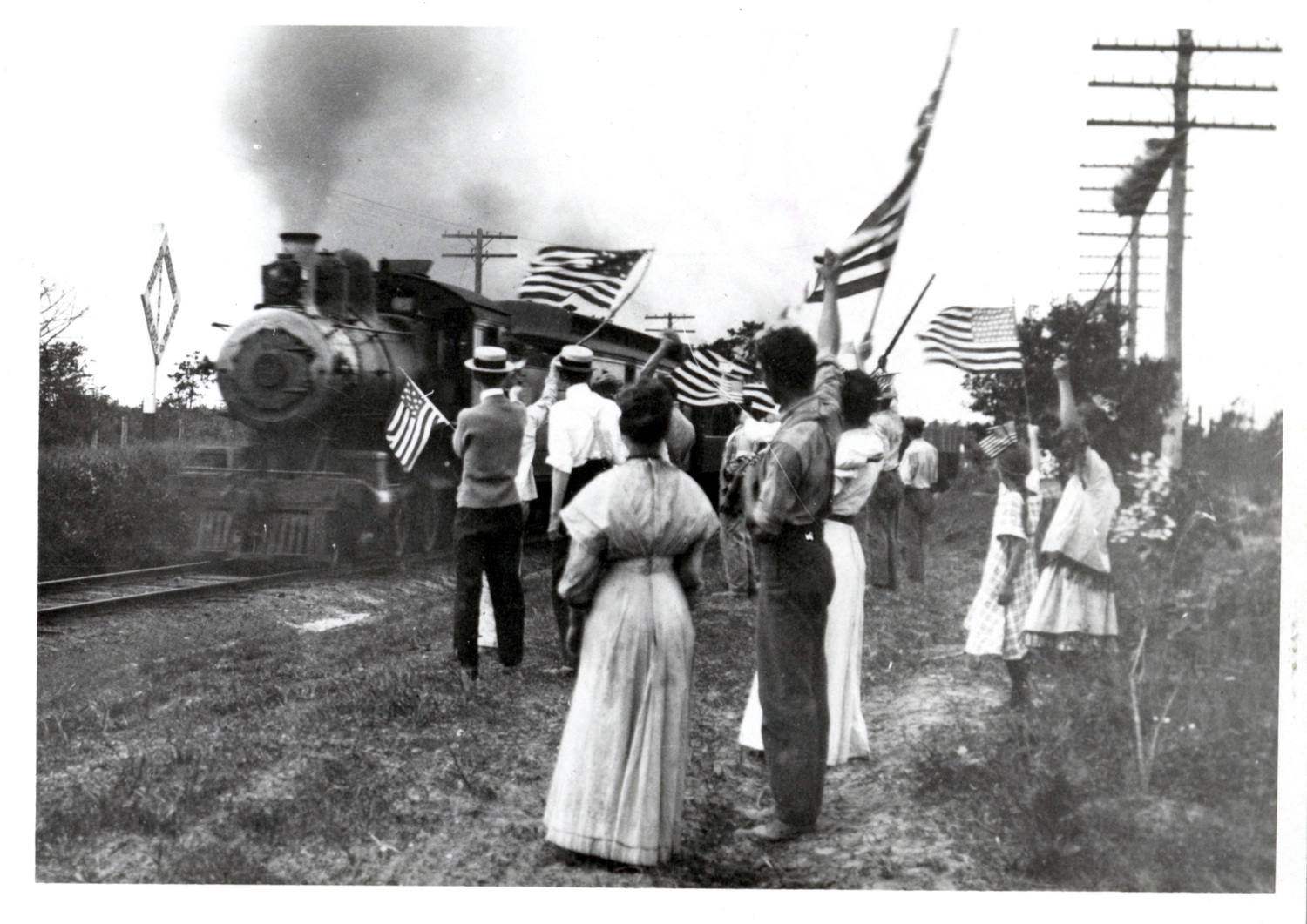 People cheering passing train (c. 1895-1905). THE EAST HAMPTON STAR PHOTO ARCHIVE, LONG ISLAND COLLECTION, EAST HAMPTON LIBRARY