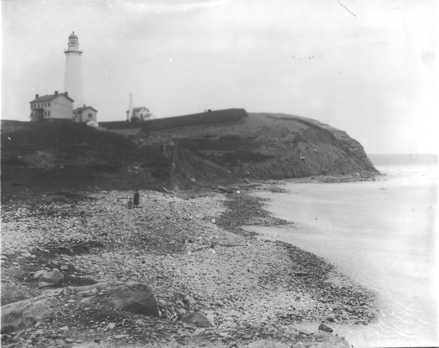 Woman and child on the beach below Montauk Point Lighthouse (pre-1902). THE EAST HAMPTON STAR PHOTO ARCHIVE, LONG ISLAND COLLECTION, EAST HAMPTON LIBRARY