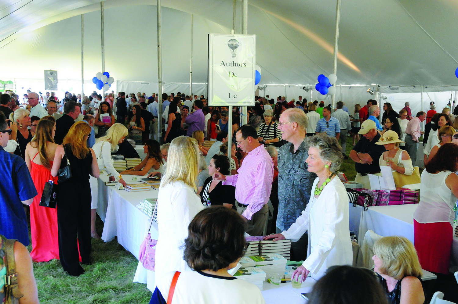 Picture of people walking around the Authors Night tent. RICHARD LEWIN