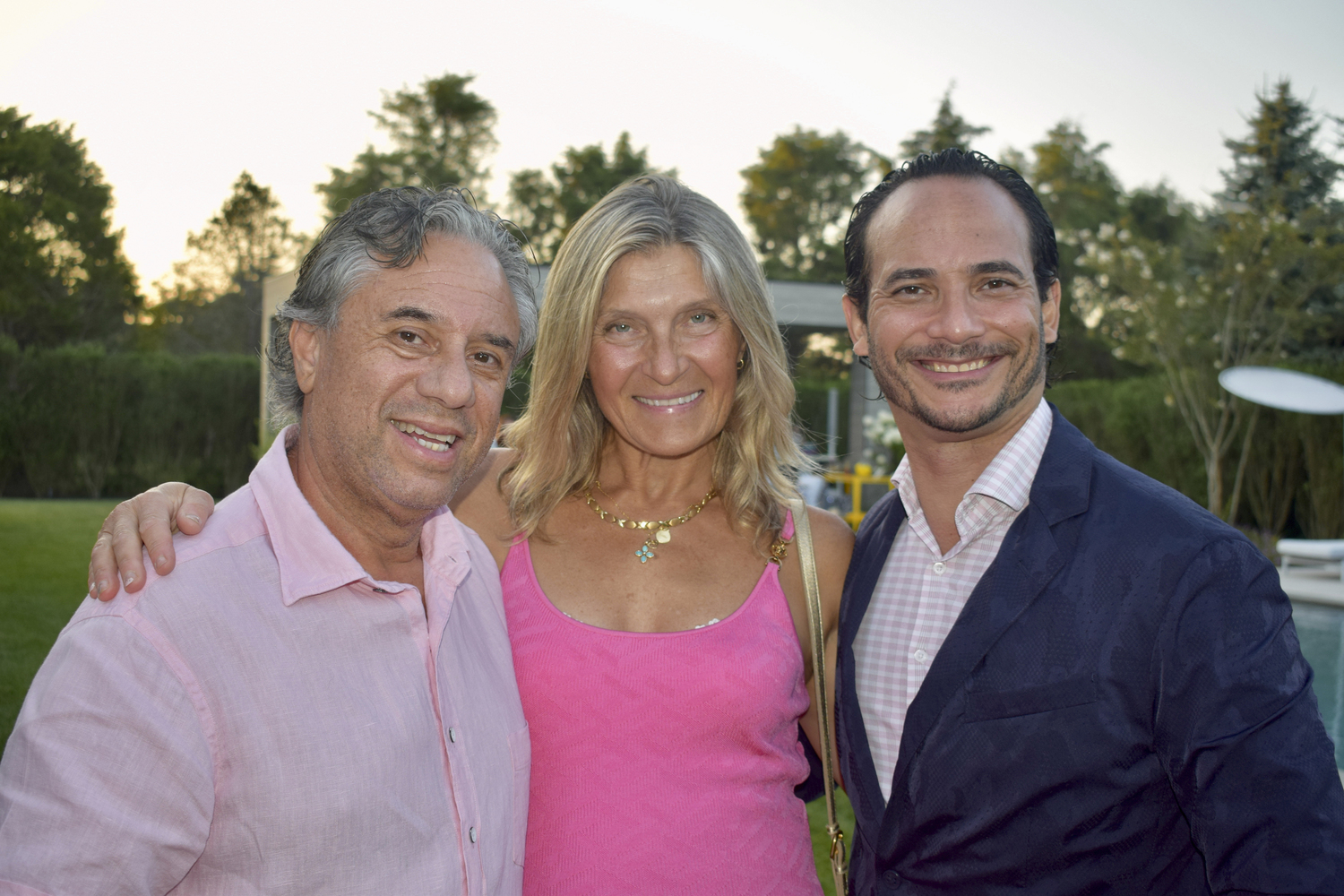 Joe Badilla, Marina Leous  and Yubal Marquez Fleites at the Holiday House Hamptons “Get on Board” on August 11. The event featured over 20 surfboards designed by local Hamptons artists, helping to raise critical funds for The Ellen Hermanson Foundation to fund the Breast Center at the Southampton Hospital.            ANGELA LAGRECA