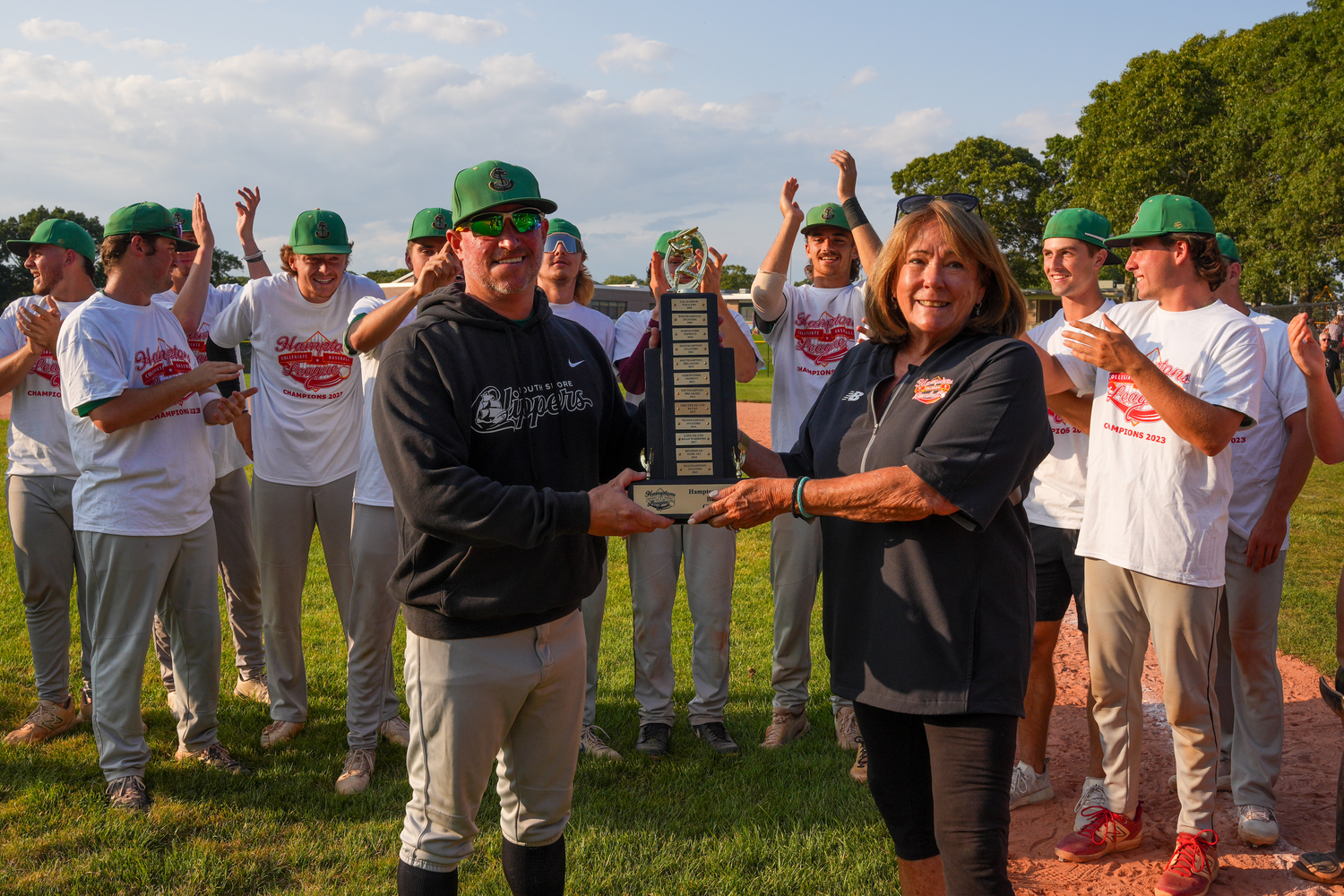 HCBL President Sandi Kruel presents the championship trophy to manager Kevin Huber and the South Shore Clippers.   RON ESPOSITO