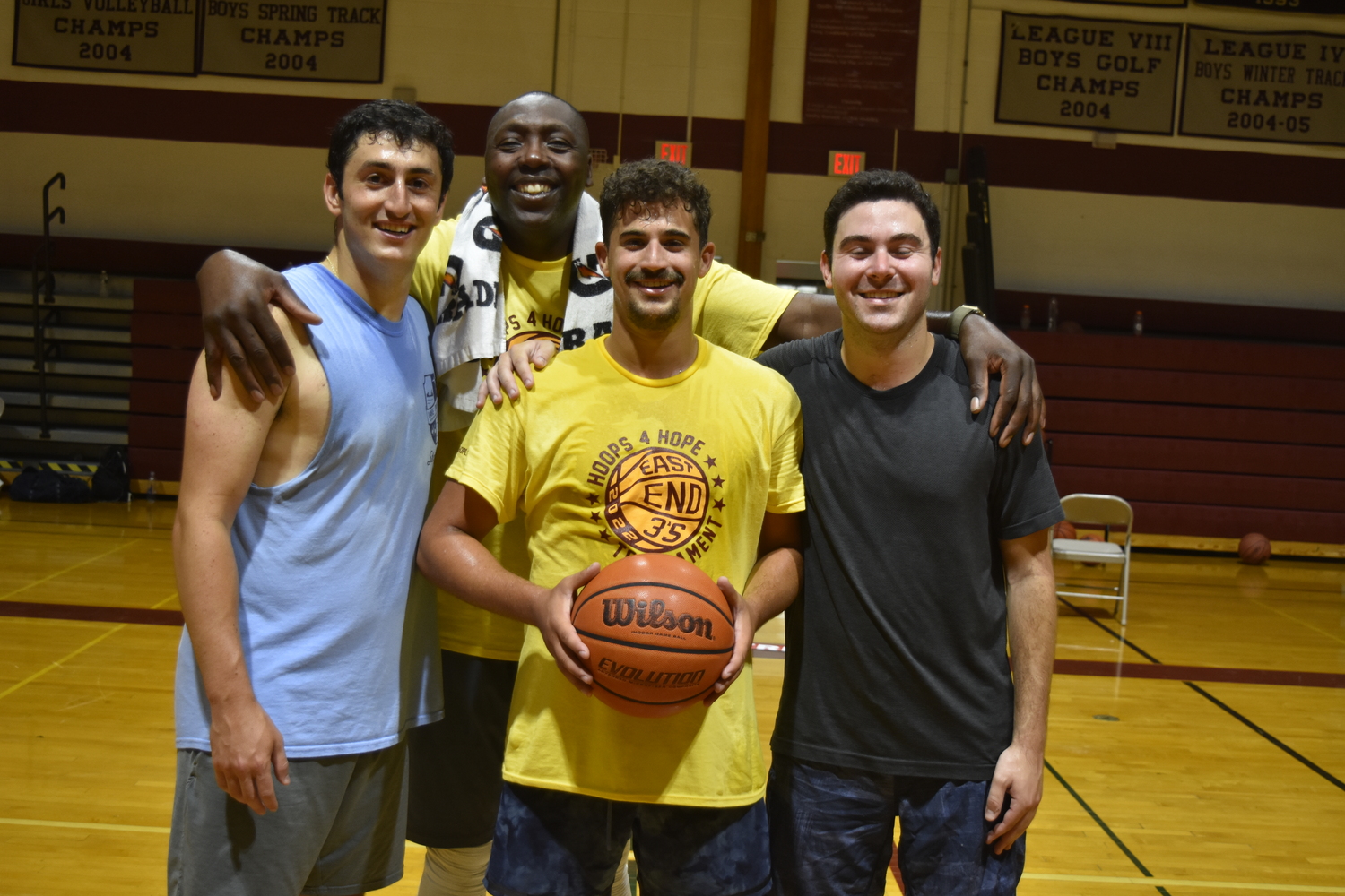 Last year's 18-and-over division champions Lawrence Edelstein, left, Nick Wiener and Ryan Essner with Levy Mwansa.   DREW BUDD