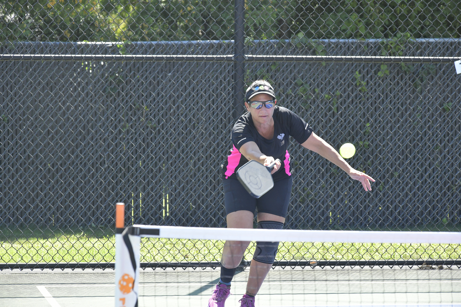 Lisa Granucci returns during the pickleball tournament at Hampton bays High School on Saturday.  DANA SHAW