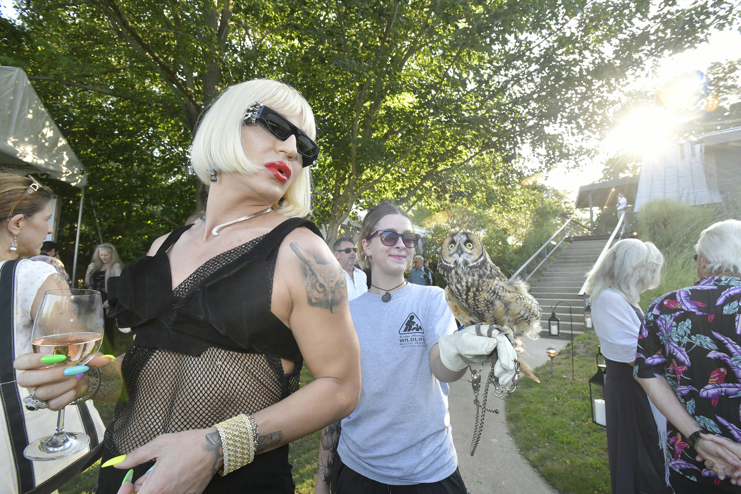 Elton Ilirjani with Emma Sanwald of the Evelyn Alexander Wildlife Rescue Center and Leona the long-eared owl.