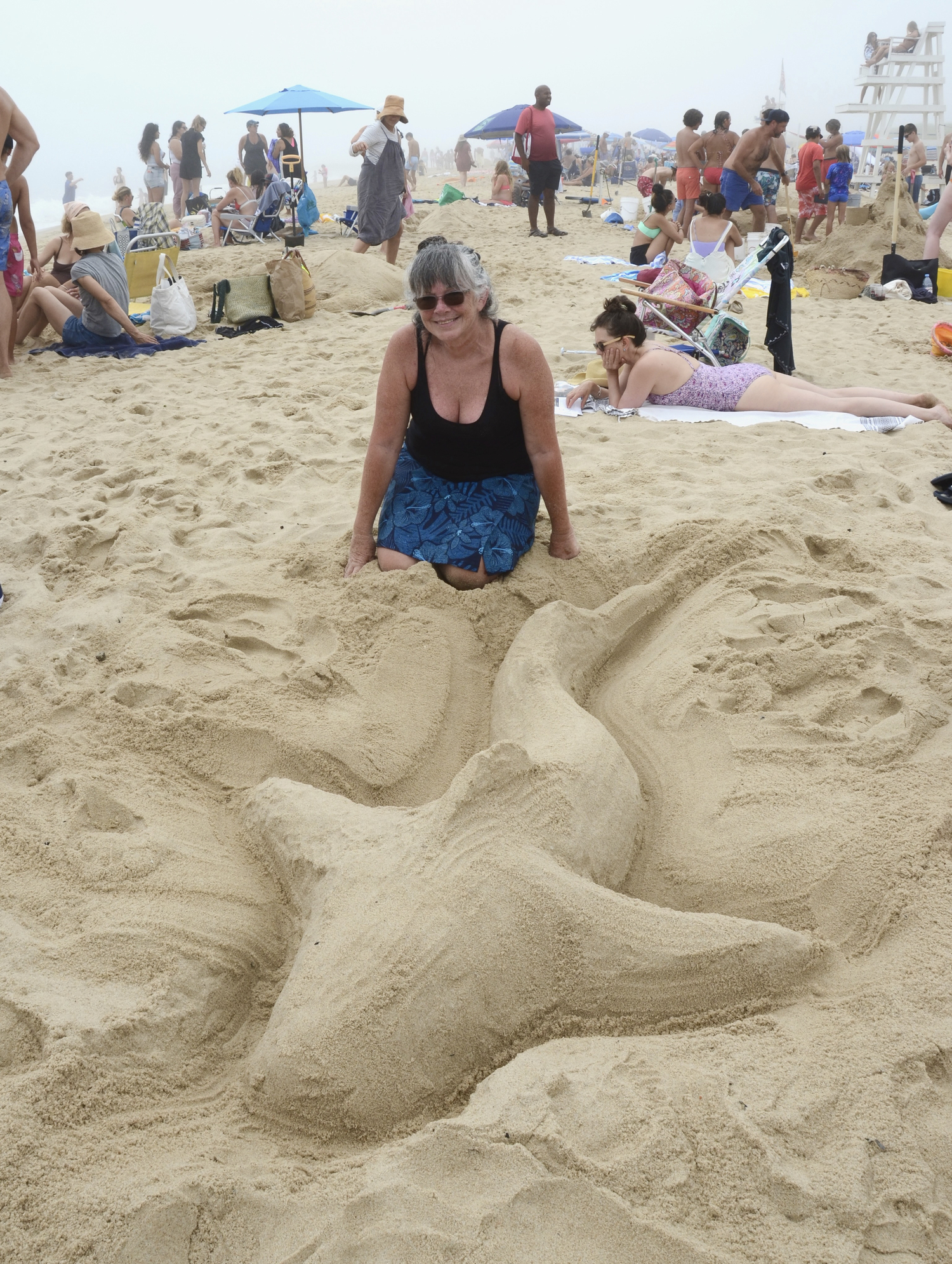 Carol Schumacher is timely with her shark sand sculpture.