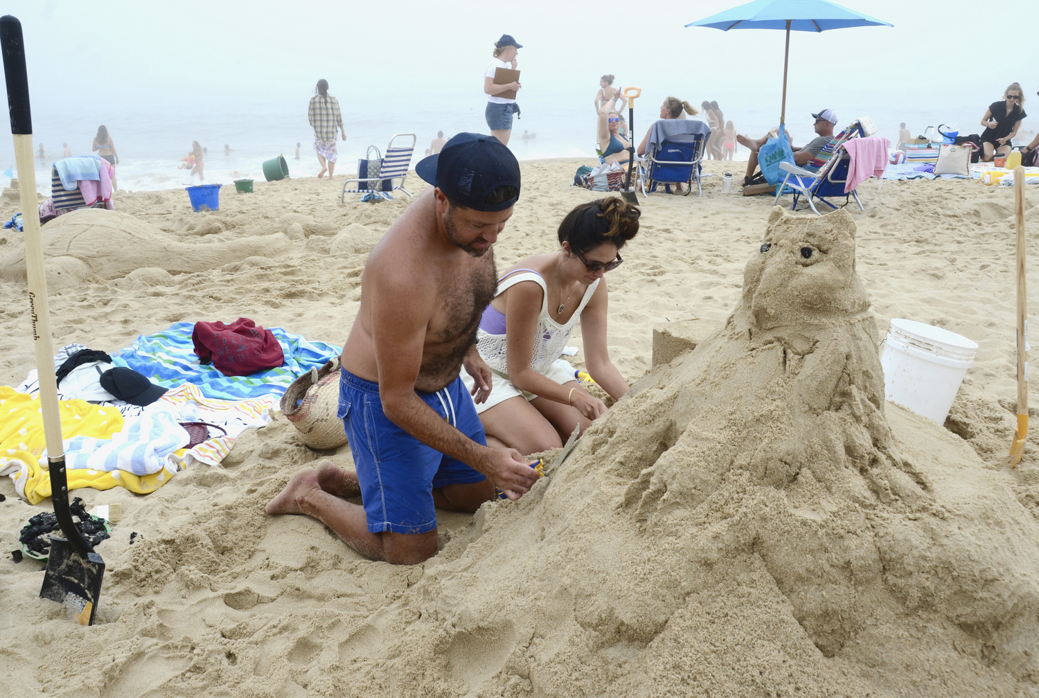 Drew Stadler and Jacqueline Lewis work on their owl sculpture.