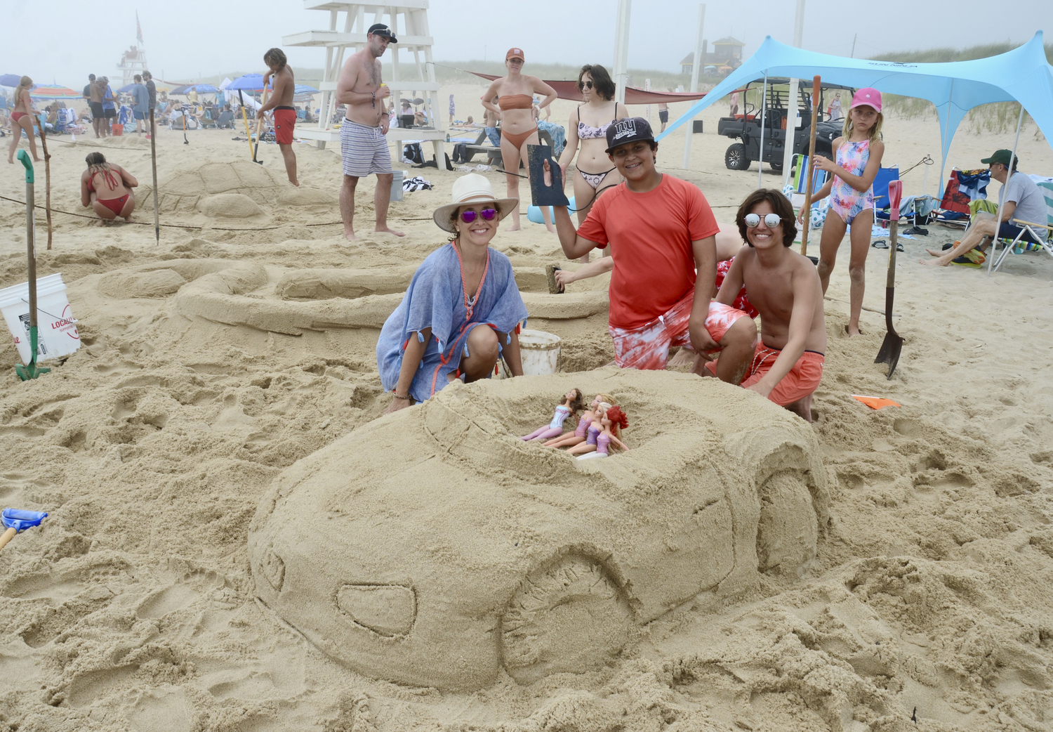 Michele Mott, Philip Cappello and Jonathan Uribe with their   “Barbiemobile