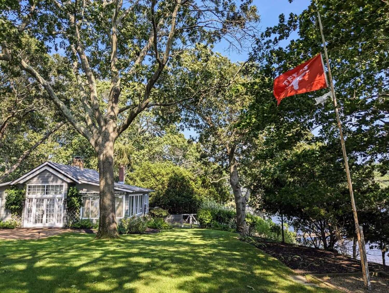 The University of Texas flag flies next to the former home of Nobel Prize-winning author John Steinbeck in Sag Harbor. Steinbeck's house is now a writer's retreat run by the University of Texas's Michener Center for Writers.