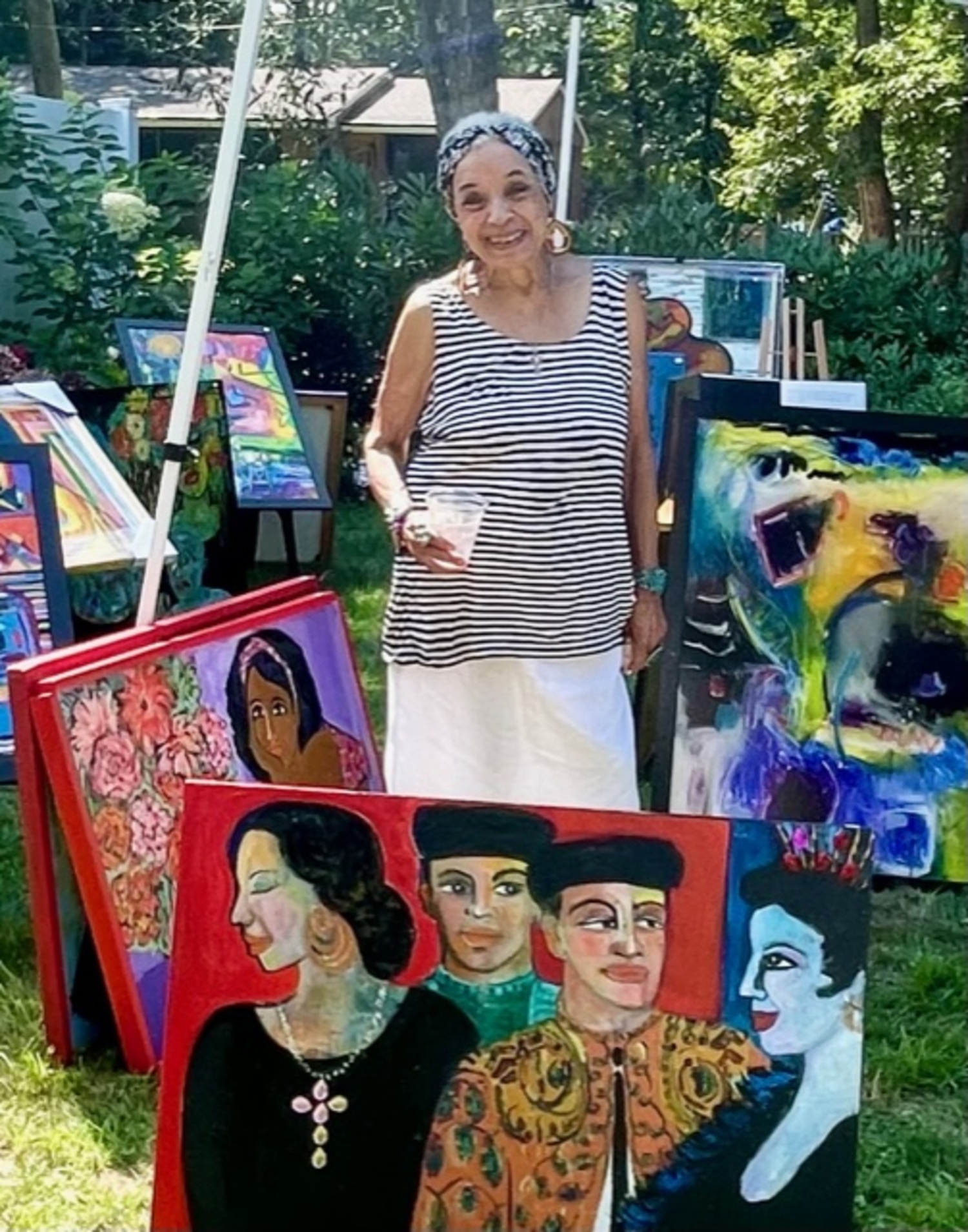 An artist at the Celebrating Creatives of Color outdoor art sale in summer 2022. COURTESY CELEBRATING CREATIVES OF COLOR COMMITTEE