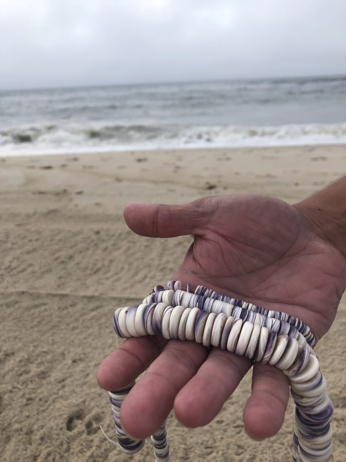 Gordell Wright displays his wampum jewelry. He will have a booth at the Shinnecock Powwow over Labor Day weekend. CAILIN RILEY