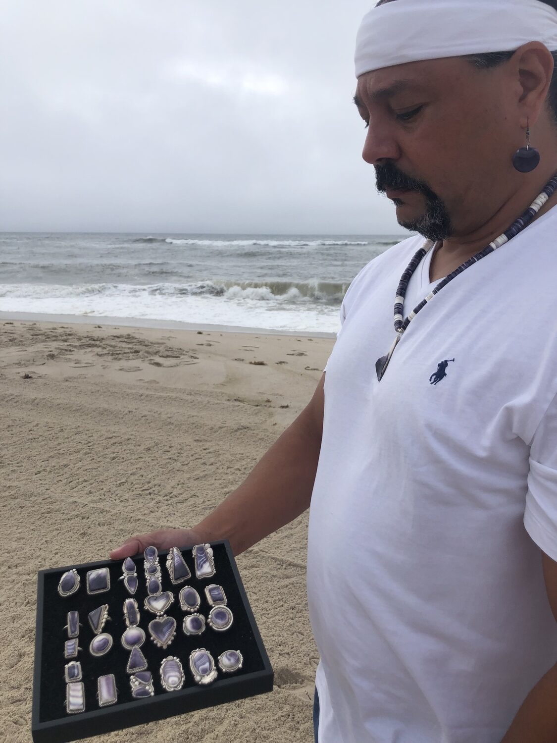 Gordell Wright displays his wampum jewelry. He will have a booth at the Shinnecock Powwow over Labor Day weekend. CAILIN RILEY