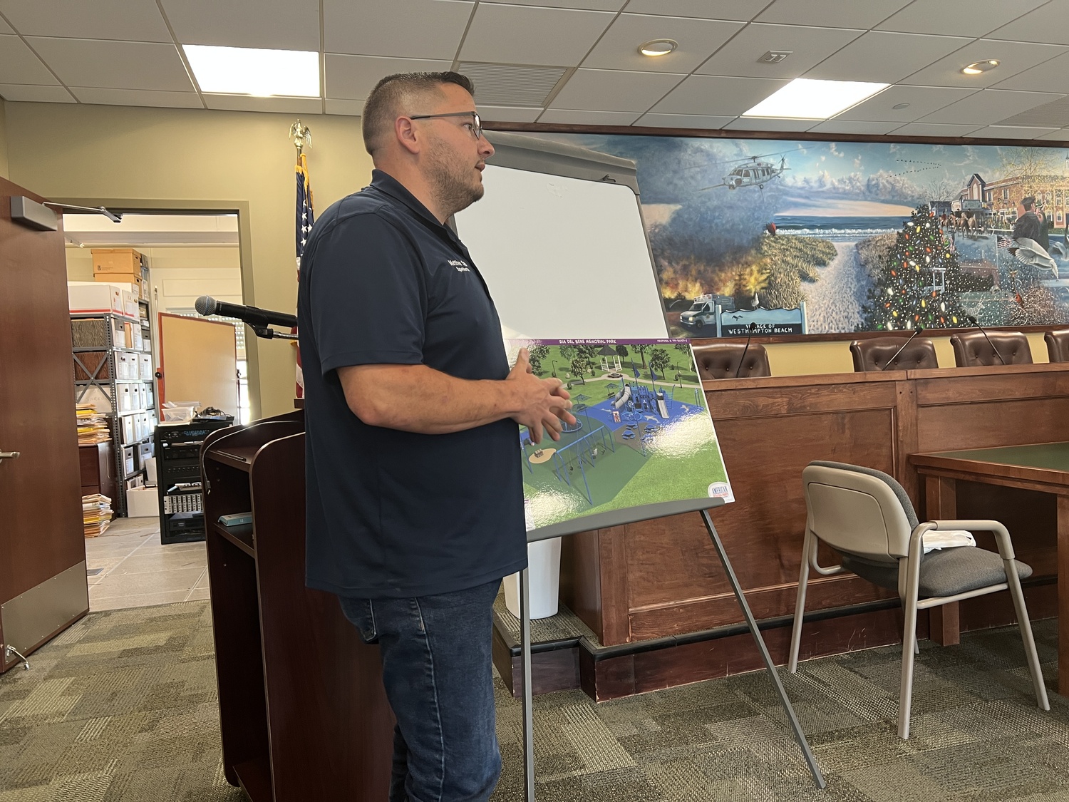 Westhampton Beach Public Works Superintendent Matthew Smith shows renderings of a redesigned playground at a Village Board meeting on July 19. BILL SUTTON