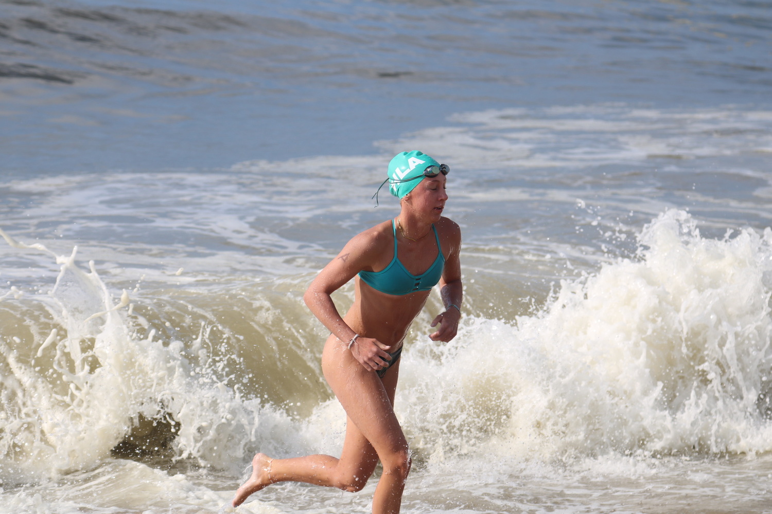 A junior lifeguard comes out of the water for the distance swim.  CINTIA PARSONS