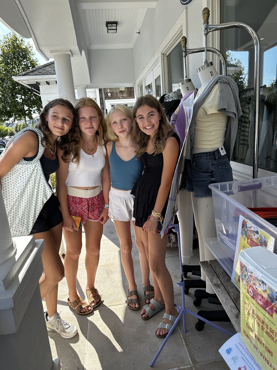 Westhampton Beach eighth-grader Leah Ravin, on far right, with friends Isabelle McCarthy, Grace Hart and Sophia Zaleski, from left to right, during her fundraising event at Mixology for Heart of the Hampton's backpack kids program. KARYN RAVIN