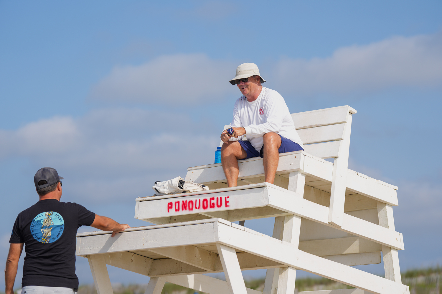 Southampton Town Chief Lifeguard Sean Crowley keeps a keen eye on everything atop a lifeguard stand at Ponquogue Beach. RON ESPOSITO