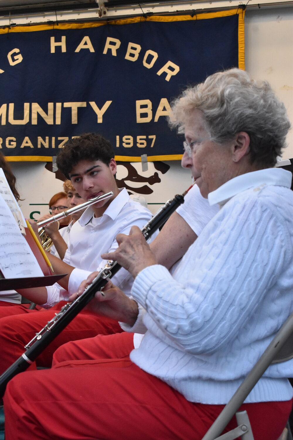 Andrew Merkert plays flute beside Irene White, a band veteran and its only oboist. STEPHEN J. KOTZ