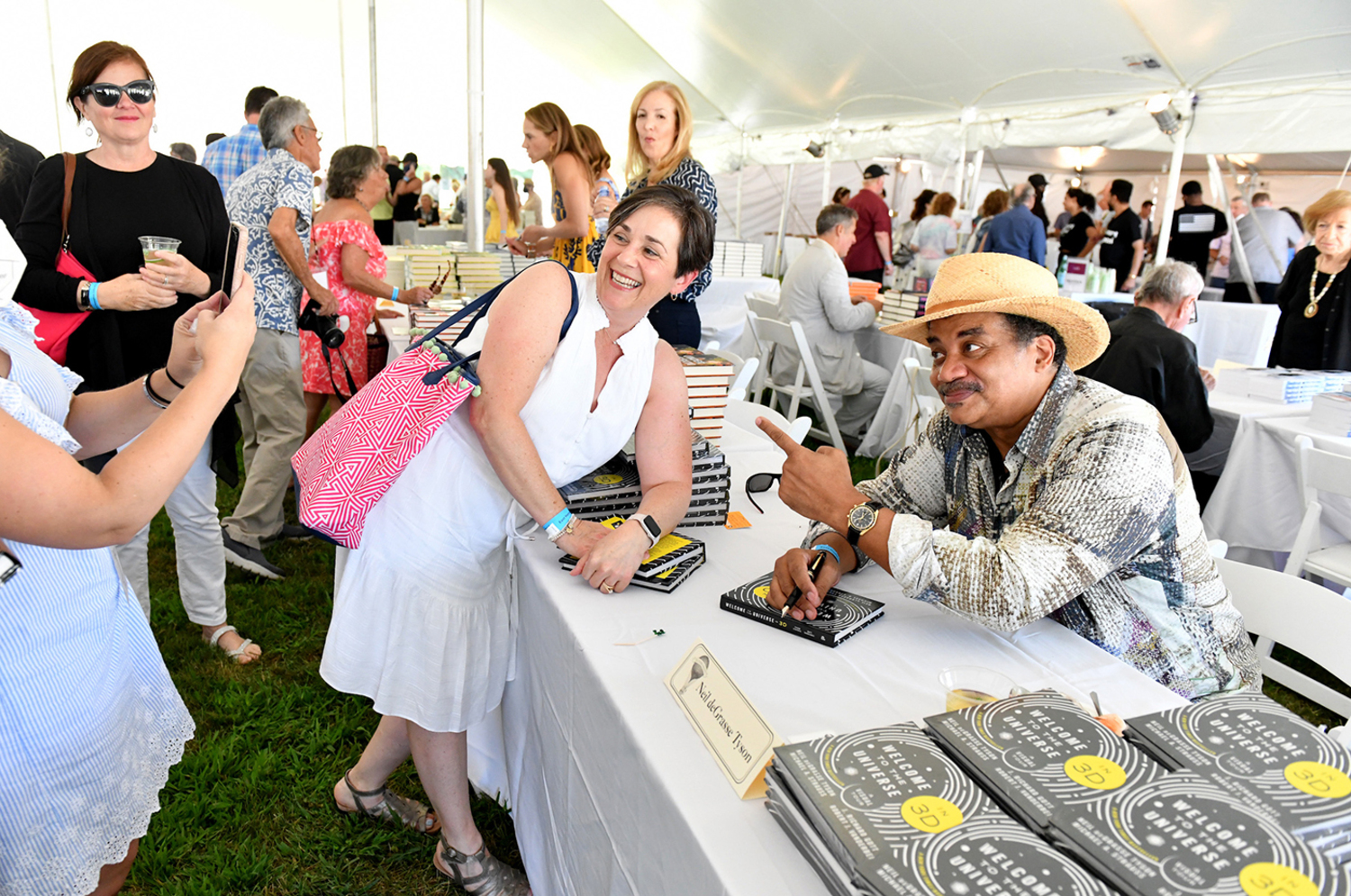 Author Neil deGrasse and a fan take a picture together at Authors Night. CRAIG BARRITT