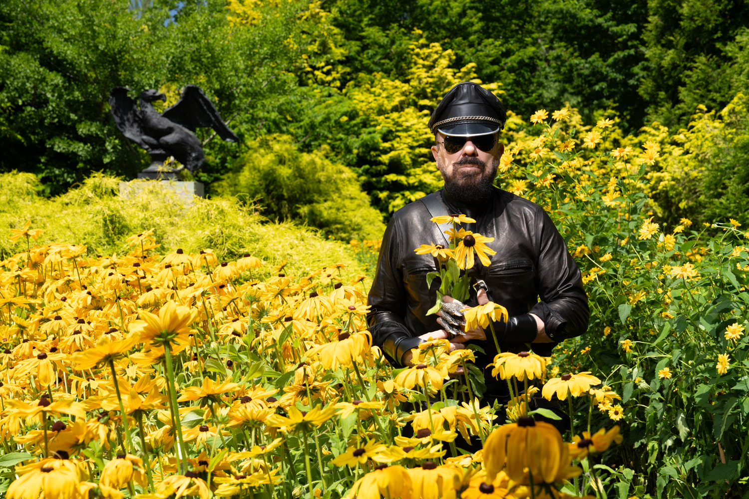 Peter Marino in the yellow garden at his Southampton home on July 22.
The bronze sculpture of an eagle is by Belgian artist Johan Creten. The garden features varieties of cypress, juniper, and daisies including black-eyed Susans and African daisies. MANOLO YLLERA