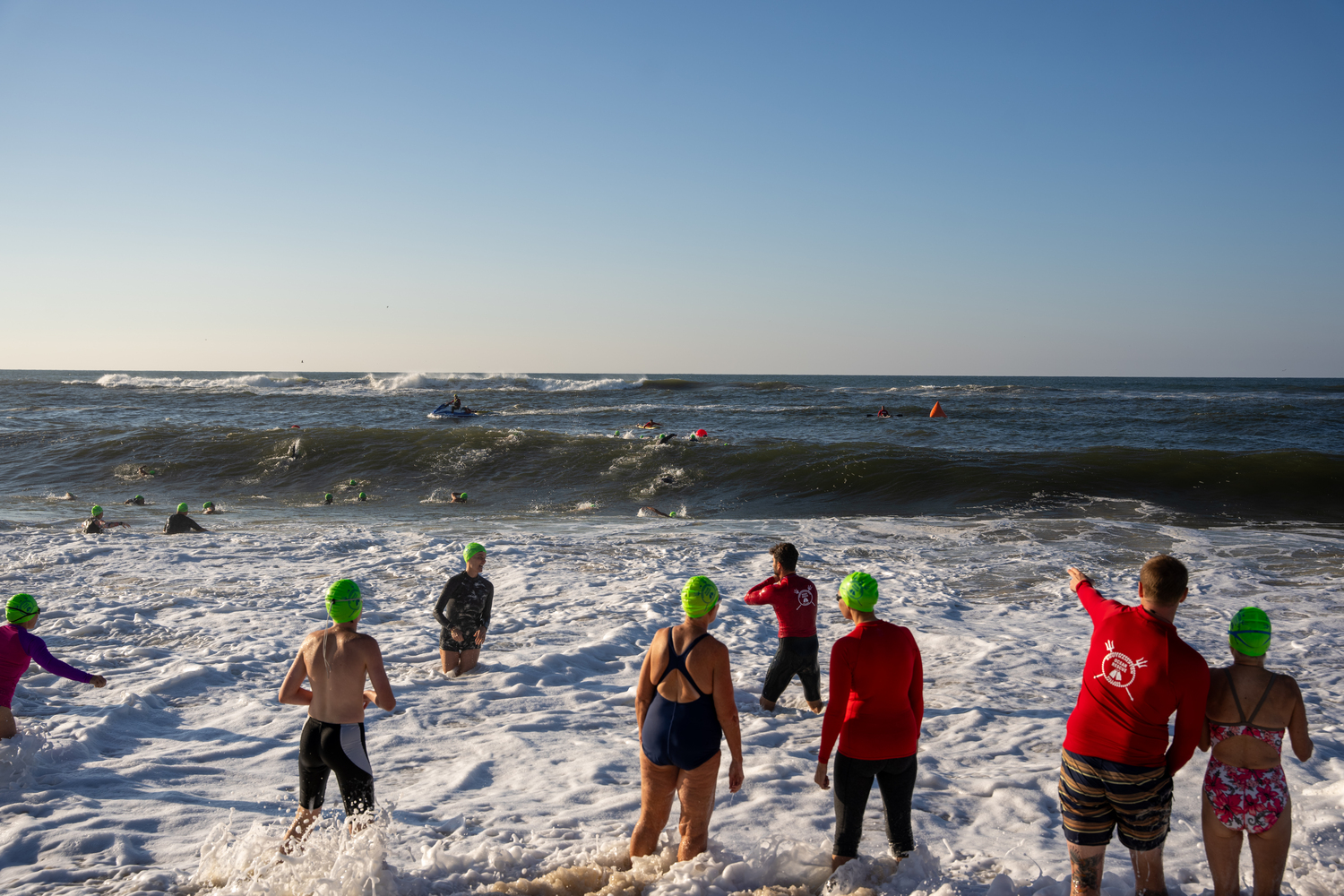 Swimmers jump right into the surf at Coopers Beach.  RON ESPOSITO