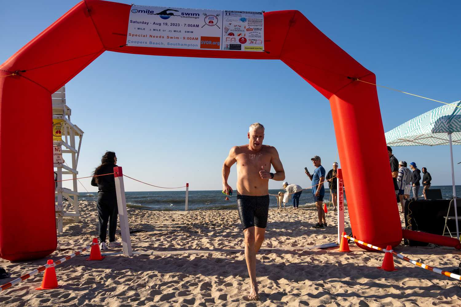 A swimmer crosses the finish line.   RON ESPOSITO