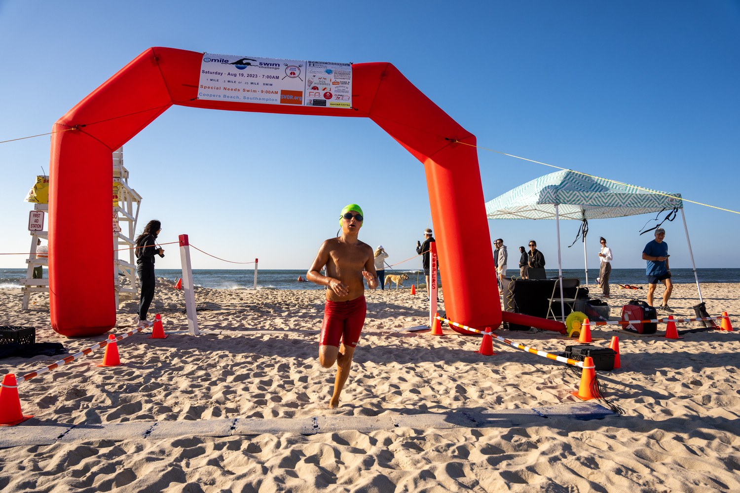 A swimmer crosses the finish line.   RON ESPOSITO