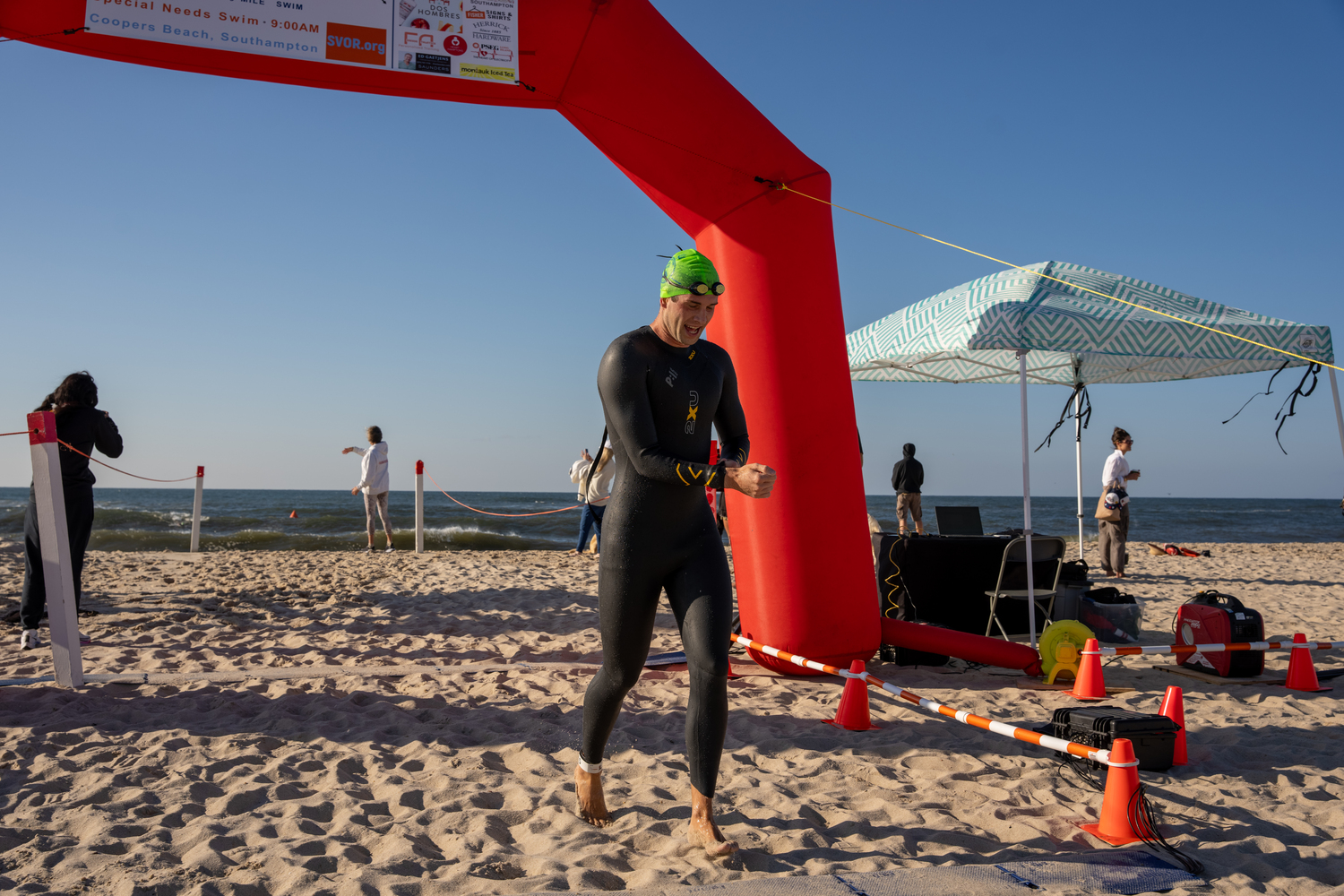 A swimmer crosses the finish line.   RON ESPOSITO