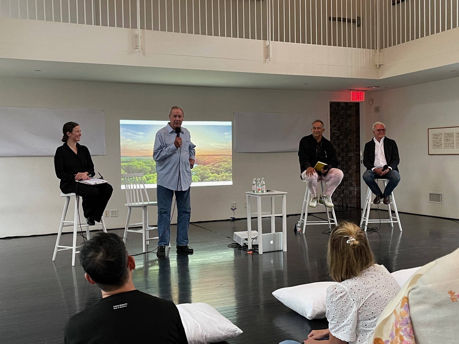 From left, Watermill Center events manager Jillian Maxwell, Watermill Center founder and artistic director Robert Wilson, architect Enric Ruiz-Geli and architect Roger Ferris. Behind Wilson on the screen is a birds-eye view of the Watermill Center property.
ANNE SURCHIN