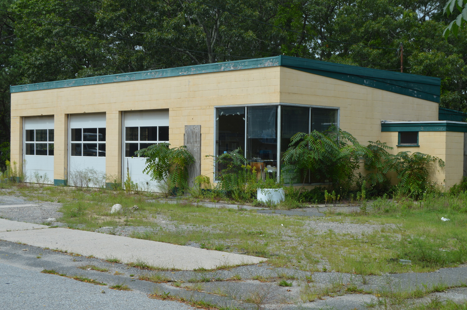 Long dormant Hampton Bays service station in midst of very long redevelopment process . TOM GOGOLA