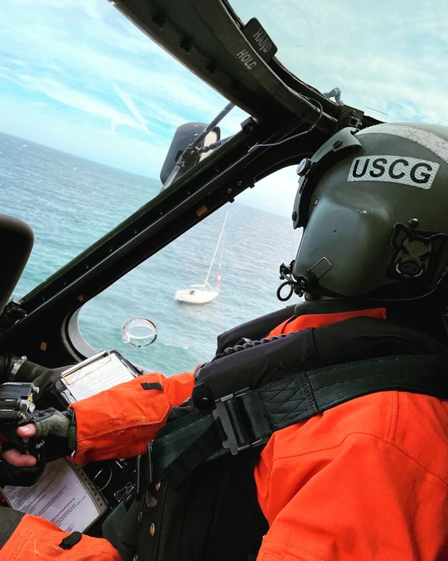 Lieutenant Commander Alex Martfeld of US Coast Guard Air Station Cape Cod flying the helicopter that was sent out to rescue two individuals aboard a 24-foot sailboat in the waters off Westhampton Beach on Friday afternoon. COURTESY USCG AIR STATION CAPE COD