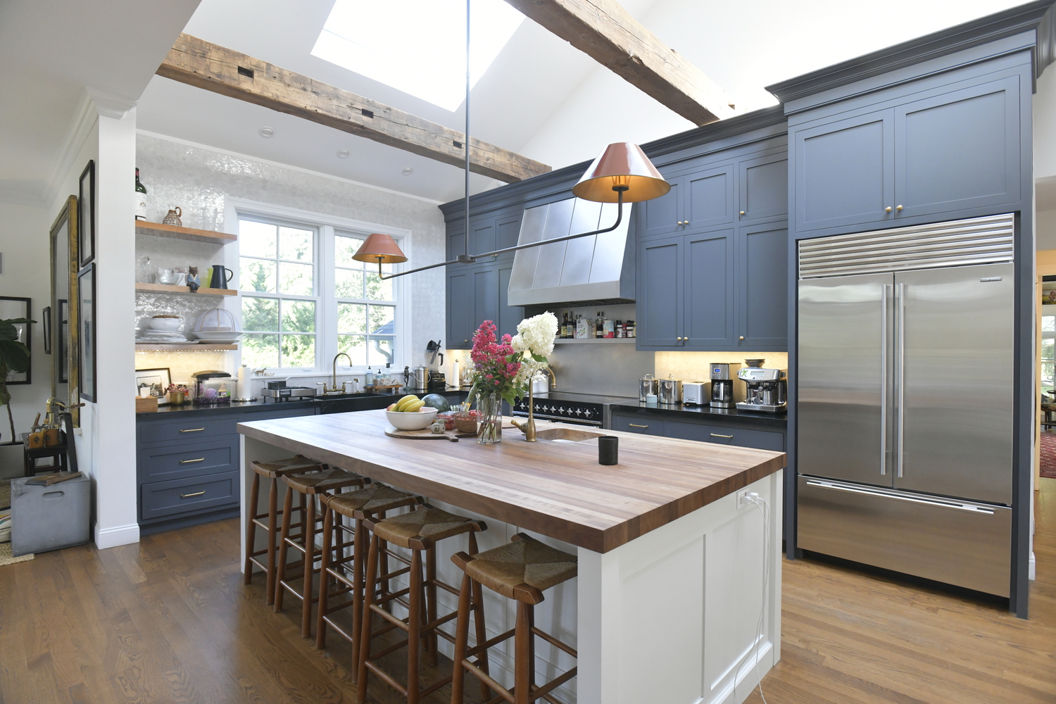 The family-sized open kitchen features a large butcher block-topped island.  DANA SHAW