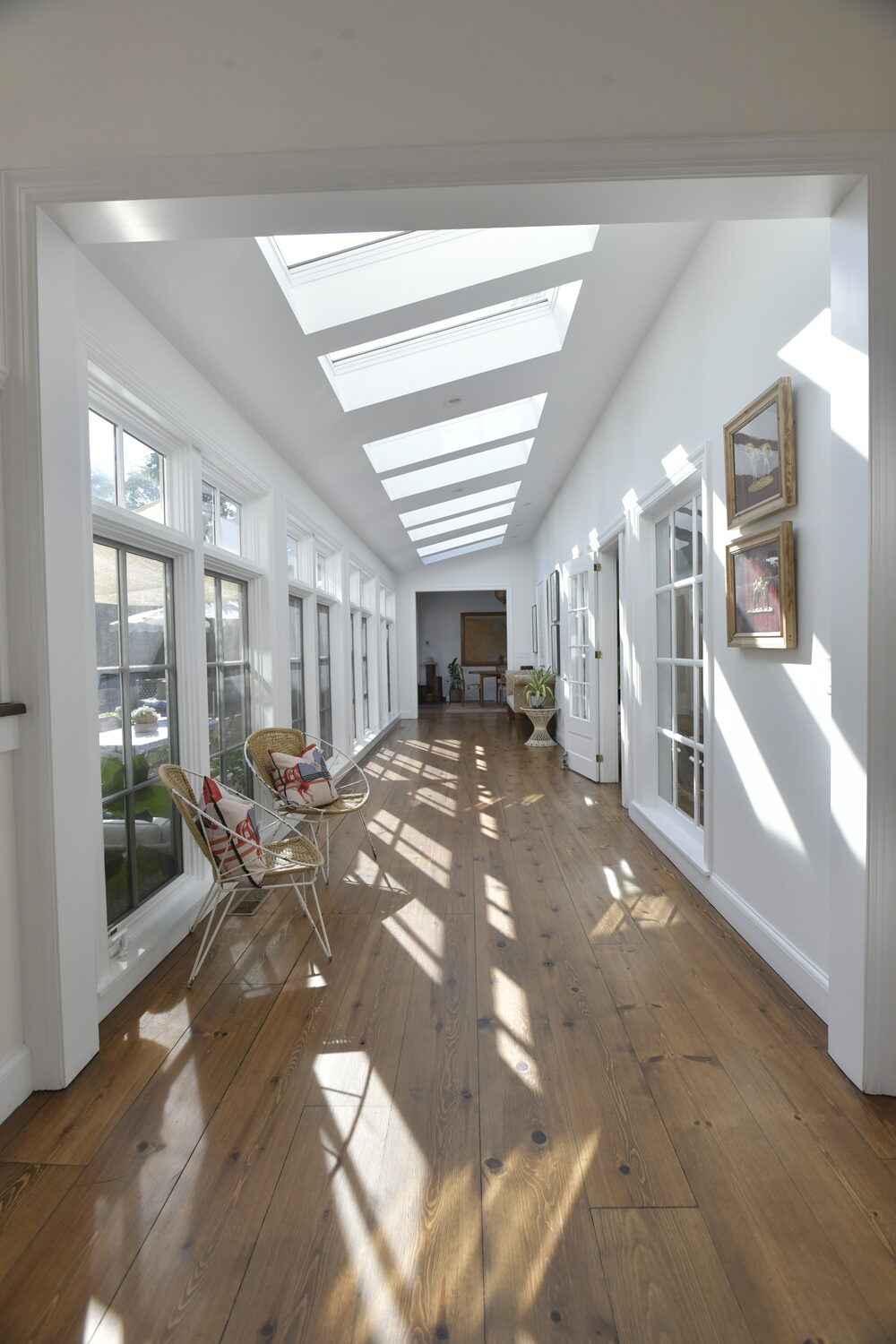 The light-filled gallery stretches from the front entry to the kitchen and great room beyond.   DANA SHAW