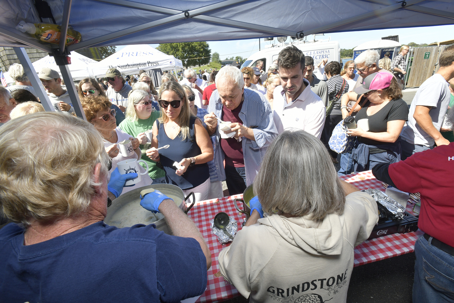 The crowd lines up to taste the offering of the Chowder Contest on Sunday.  The Dock House took first place in the contest with Page coming in a runner up.   DANA SHAW