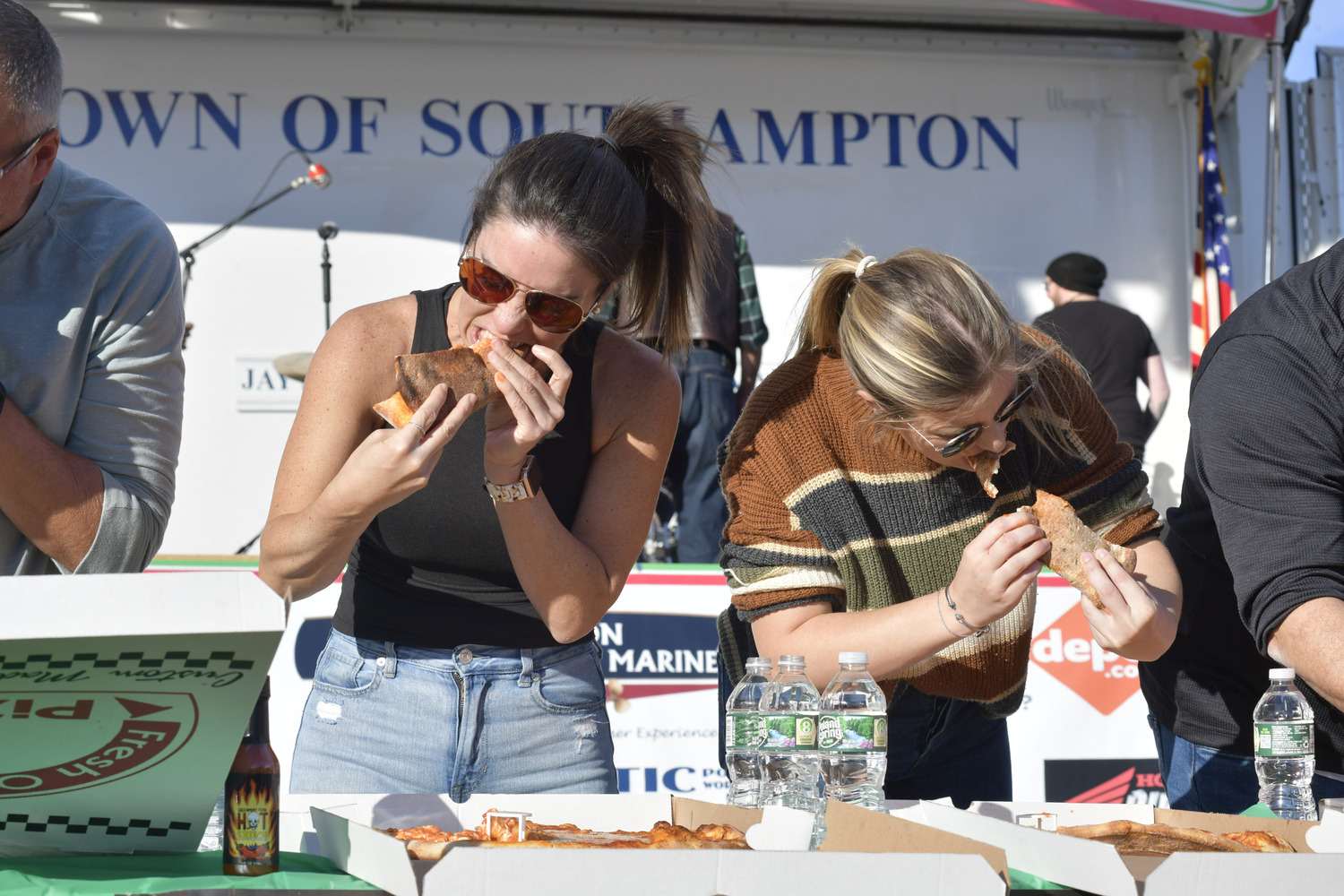 Ashley White and Arianna Tomeo during the pizza eating contest at the San Gennaro Festival last year.   DANA SHAW