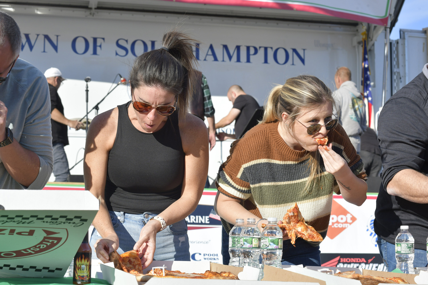 Ashley White and Arianna Tomeo during the pizza eating contest at the San Gennaro Festival last year.   DANA SHAW