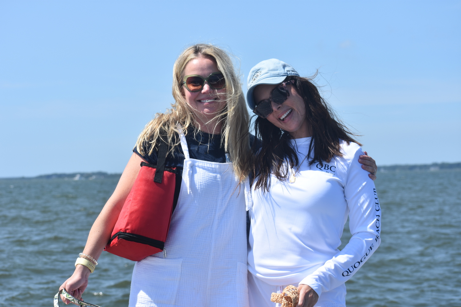 Sarah Connett, left, and Dina Suta take in the scene at Westhampton Yacht Squadron which hosted a number of different races on Saturday. DANIEL FLYNN