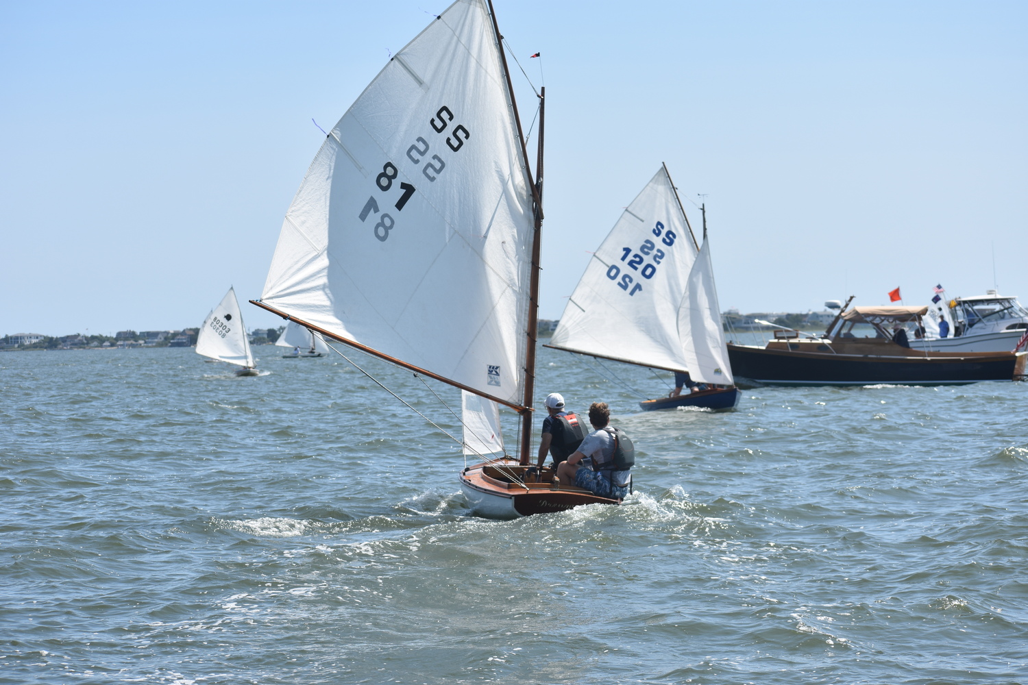 Boats cross the finish line.  DANIEL FLYNN